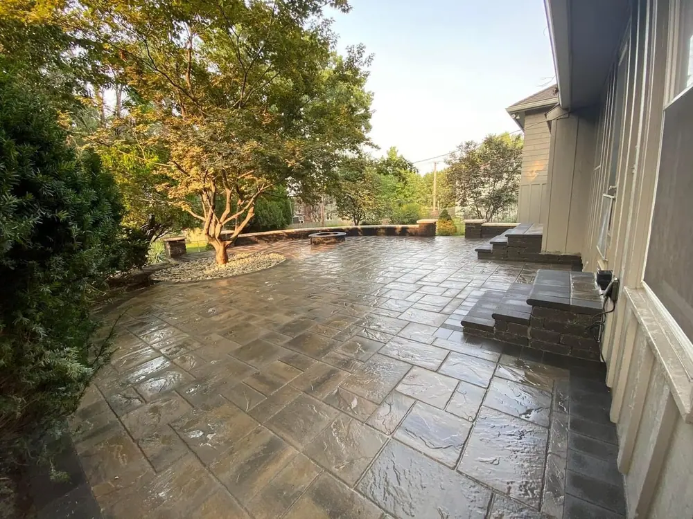 Large natural flagstone patio with stone steps beside a home
