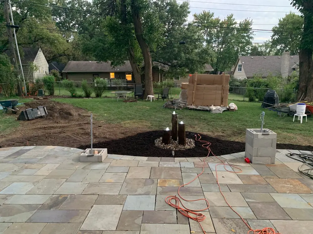 Cedar pergola over a deck with a white picket railing and fresh landscaping